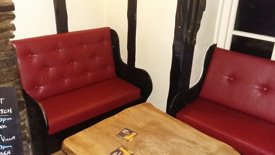 red reupholstered leather chairs in pub